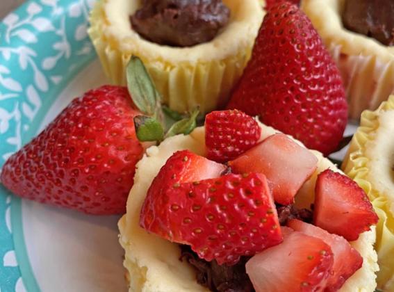 CHOCOLATE AND CHEESECAKE A dollop of chocolate ganache before topping with strawberries gives this batch of muffins a “chocolate-covered-strawberry” effect. | ANGELINA LaRUE PHOTOS